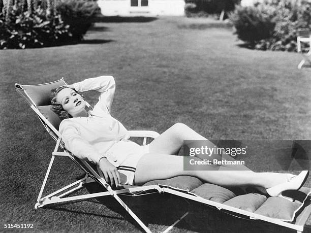 Movie actress Marlene Dietrich takes it easy in a beach chair.