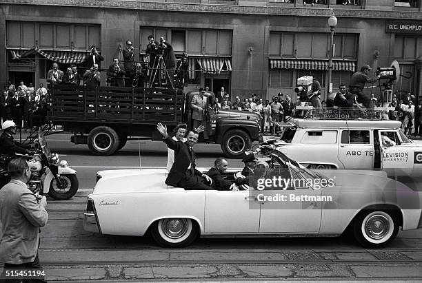 Washington, D.C.-: Astronaut Alan B. Shepard, Jr. And his pretty wife, Louise, wave to crowds during a parade from the White House to the U.S....