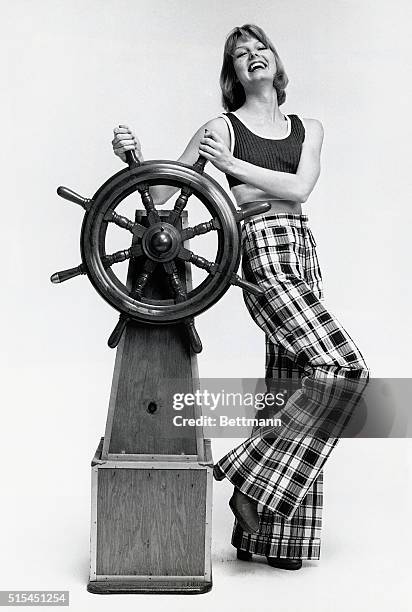 Photo shows a young model posed at a ship's wheel. For smooth sailing on the fashion sea, Longjons offers these 100% cotton slacks with flapped...