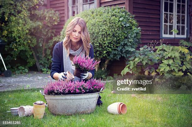 woman in garden. - huis ter heide stockfoto's en -beelden