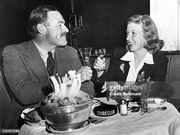 Newlyweds Ernest Hemingway and Martha Gelhorn make a toast at the Stork Club.