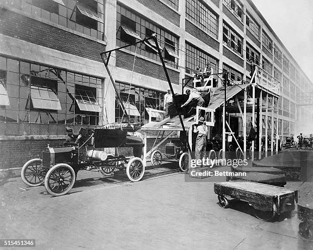 Reconstruction of the first Ford assembly line at the company's Highland Park plant near Detroit, Michigan. Automobile bodies are sent down a ramp...