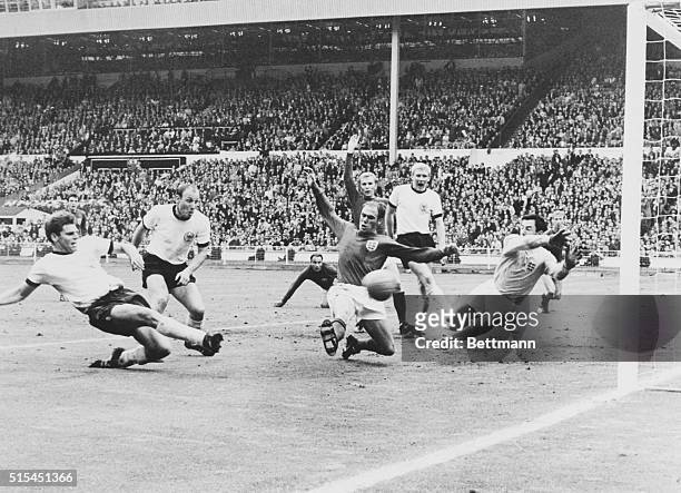 Wembley, England-ORIGINAL CAPTION READS: Wolfgang Weber of West Germany scores his team's second goal as England's Ray Wilson and goalie Gordon Banks...