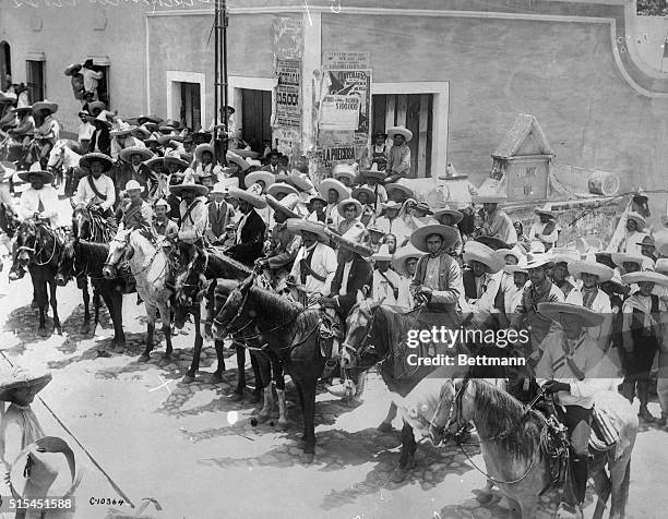 Mexico City, Mexico-Emiliano Zapata and his brother Eufemio Zapata , head their personal body guard in the streets of Mexico City. These men are...