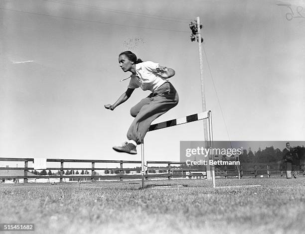 Helsinki, Finland- Miss Wanda Dos Santos, of the 1952 Brazilian Olympic Team, takes a hurdle with graceful agility, during a training session at...