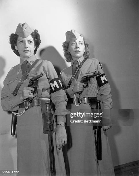 Sergeant Beulah Jackie Coates and Private Marjorie Shepherd holding guns. They were among the first seven members of the Women's Army Corps to become...