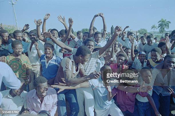Port-au-Prince, Haiti- Haitians jump and dance for joy on the street in front of the National Palace, in celebration of Jean-Claude Duvalier's flight...