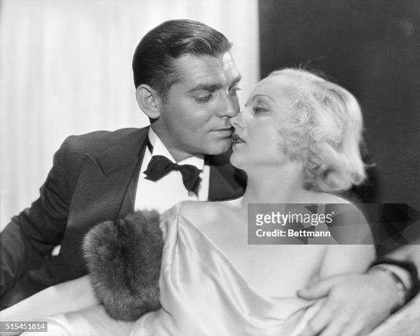 Studio portrait of Clark Gable and Carole Lombard kissing. The couple made one film together, No Man of her Own 1932 and were married in 1939 until...