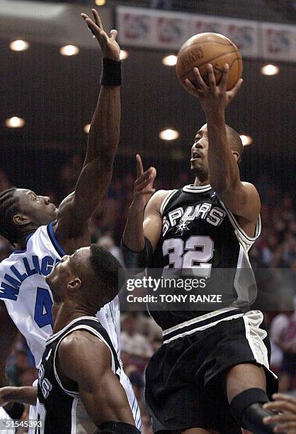 Orlando Magic forward Ben Wallace blocks a shot from San Antonio Spurs' forward Sean Elliott before Spurs' center David Robinson during the first...