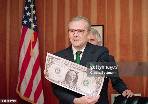Washington, DC-: Treasury Secretary Nicholas Brady displays a giant replica of a U.S. Dollar bill with his signature on it, during a ceremony at the...