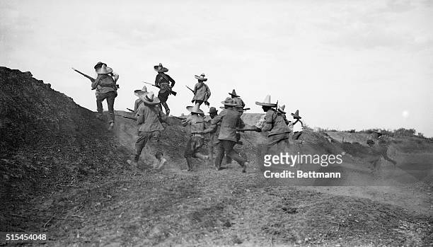 Mexican Revolution of November, 1913. Photo shows Pancho Villa's troops rushing the federal lines under protection of cannon fire.
