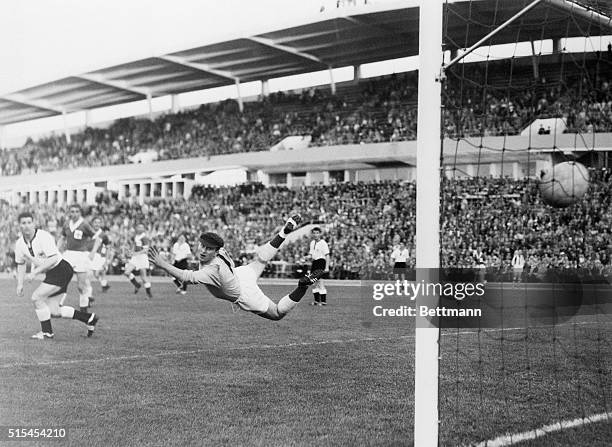 Northern Ireland's goalie, Harry Gregg, makes a graceful dive but misses the ball as West Germany's Uwe Seeler scores during the World Cup soccer...