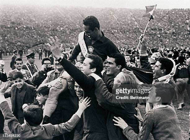 Santiago, Chile-: Jubilant fans hoist Brazilian goalie Gilmar on their shoulders at National Stadium after Brazil beat Czechoslovakia, 3-1, to retain...
