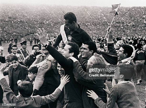 Santiago, Chile-: Jubilant fans hoist Brazilian goalie Gilmar on their shoulders at National Stadium after Brazil beat Czechoslovakia, 3-1, to retain...