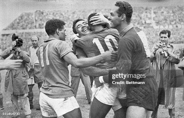 Stockholm, Sweden-: Jubilant team members hug Pele , who scored the winning goal for Brazilians in their World Cup victory over the Swedish soccer...