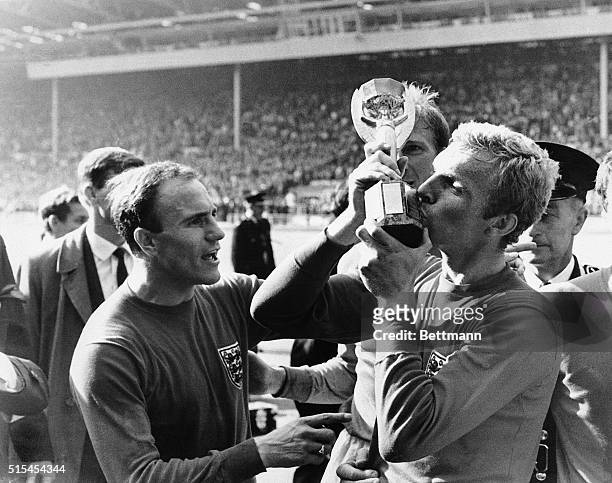 Wembley, England-: England's Bobby Moore kisses the Jules Rimet Cup following his team's defeat of West Germany in the World Cup Soccer Championship...