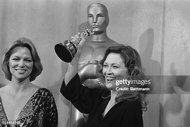 Hollywood, California-: Actress Faye Dunaway holds the "Oscar" over her head in excitement at the 49th Annual Academy Awards at the Music Center. Ms....