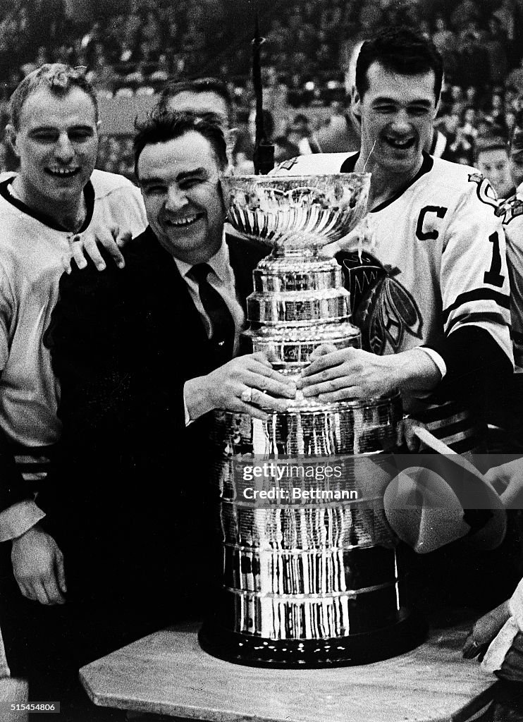 Coach and Players Embrace Stanley Cup