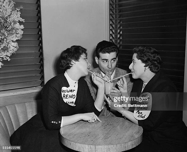 Ted Reno, an Italian recording star, tickles the ivories and a couple of U.S. Fan club members as he provides a song during a Chicago meeting. Donna...