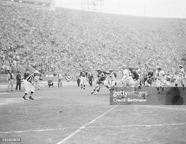 Eastern conference halfback Ollie Matson 933) is hit by Western conference halfbacks Jack Christiansen and Bert Rechichar as Matson nears the goal...