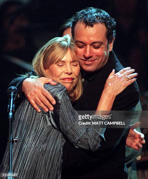 Singer Joni Mitchell gets a hug from ex-husband Larry Klein at the end of the taping of Turner Network Television's "All-Star Tribute to Joni...