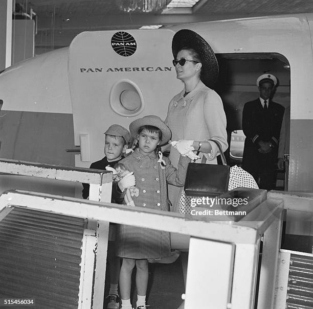 Princess Grace of Monaco and her children, Albert and Caroline who hugs dolls, board a Paris-bound plane at Idlewood on their way home after a...