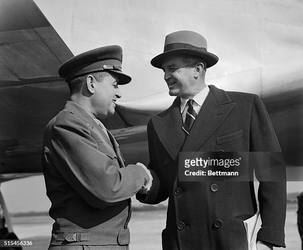 Lt. General Curtis E. LeMay organizer of Berlin's famed "Operation Vittles" is shown receiving congratulations from Air Secretary, W. Stuart...