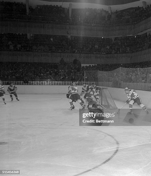 During the Olympic hockey tournament in the Winter Games at Cortina, February 3, Russian goalie Nikolai Puchkov and a Soviet defenseman block a...