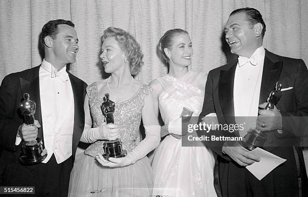 Four smiling film stars pose for photographers at the Pantages theater in Hollywood, March 21st, after the presentation of the 28th annual Academy...