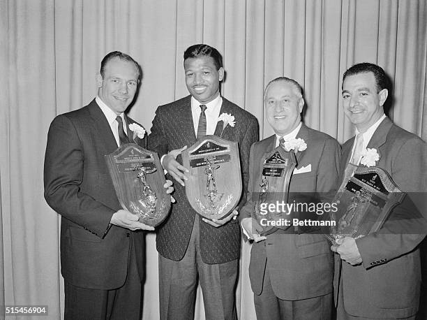 Four famous boxing personalities proudly hold plaques they received as awards from the Chicago Boxing Writer's and Broadcaster's Association here...