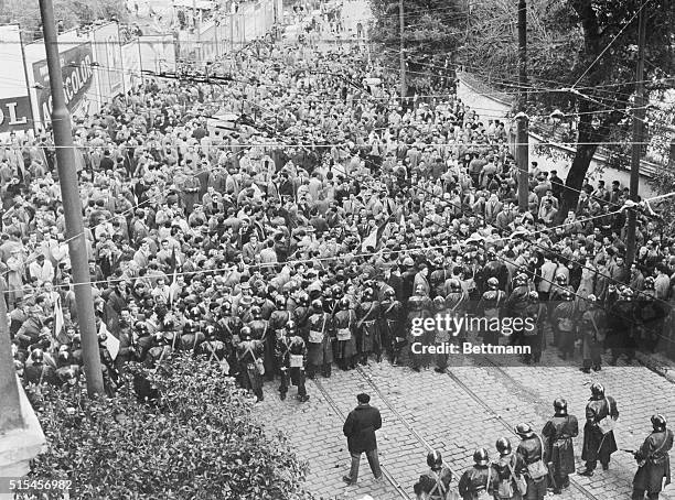 Lines of helmeted security guards block the advance of French demonstrators marching on the Summer Palace where French Premier Guy Mollet retired...