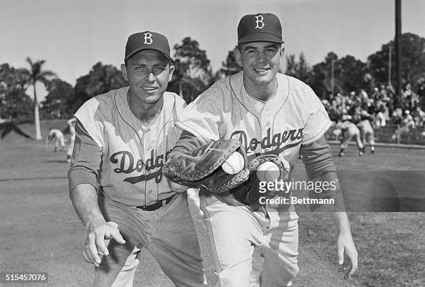 Right-handed Gil Hodges of the world champion Brooklyn Dodges shows some of the fine points of manning first base to left-handed Jim Gentile,...