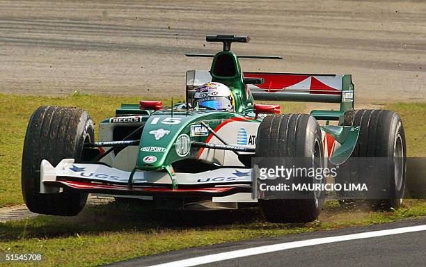 Austria's Formula One driver Christian Klein takes the grass after lost the control of his Jaguar 22 October 2004, during the practices at Interlagos...