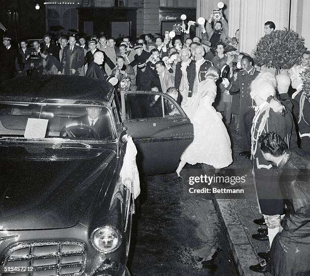 Actress Grace Kelly arrives in the rain at the Monte Carlo Sporting Club April 15th for a $100,000 ball held in honor of Miss Kelly and Prince...