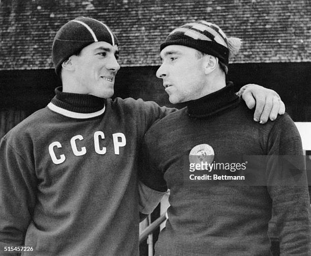 Rafael Gratsch and Eugenev Grishin, members of the Russian skating team scheduled to compete in the 1956 Winter Olympics, strikes a mutually...