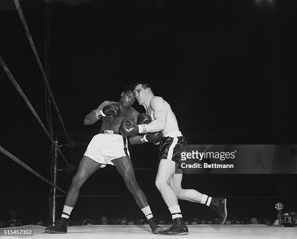 Gil Turner lands a left to the midriff of Gene Fullmer, who lands with his own during the fourth round of their middleweight bout at the Garden....