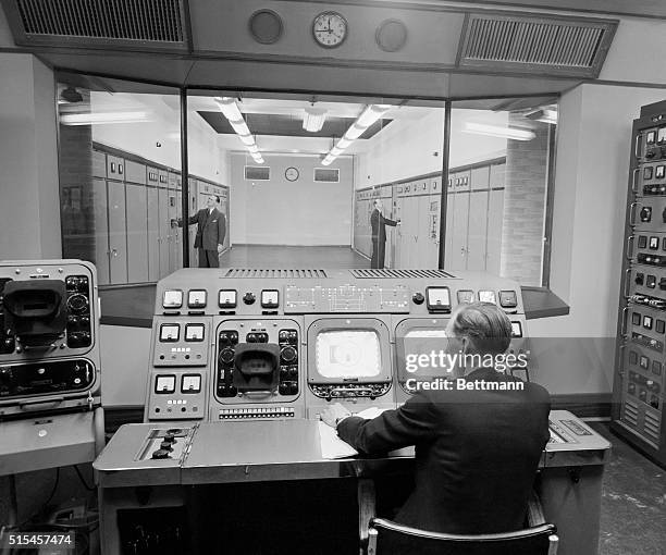 Monitors for incoming and outgoing signals are observed by a technician at the new TV transmitting station for the BBC, at London's Crystal Palace....