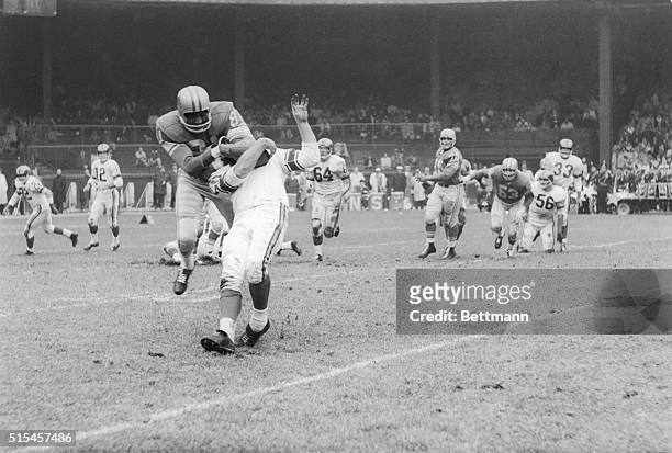 Ram halfback Jon Arnett is stopped by a head-lock thrown by Lion Dick 'Night Train' Lane after he gathered in a pass from Zeke Bratkowski during the...