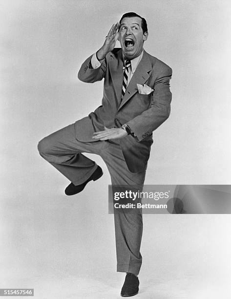 Milton Berle clowns for the camera with a jig.