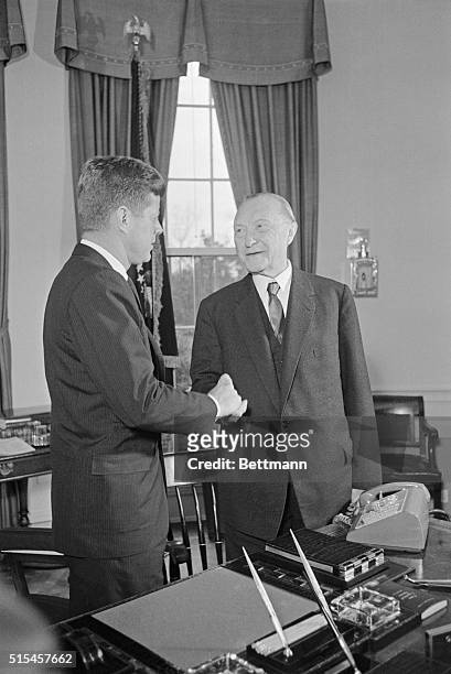President Kennedy shakes hands with Chancellor Konrad Adenauer of West Germany in the Oval Office.