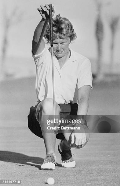 Defending champion Mickey Wright of Dallas, Texas, uses her club to get a line on a putt at the Stardust Golf Course in Las Vegas. She fired a 77...