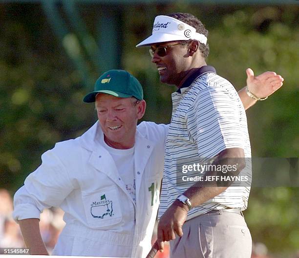 Vijay Singh of Fiji is hugged by his caddie David Renwick after Singh made the final putt on the 18th green 09 April, 2000 to win the Masters Golf...