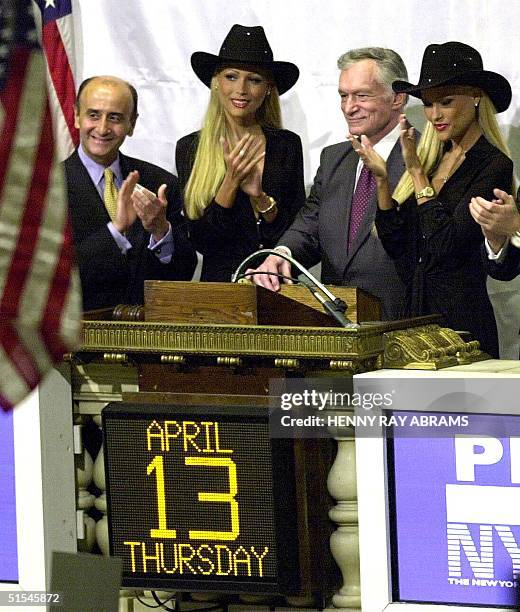 Playboy Chairman Emeritus and Founder Hugh Hefner rings the closing bell at the New York Stock Exchange 13 April, 2000 surrounded by his girlfriends...