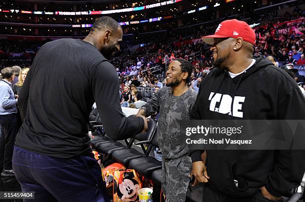 Kendrick Lamar greets LeBron James at a basketball game between the Cleveland Cavaliers and the Los Angeles Clippers at Staples Center on March 13,...