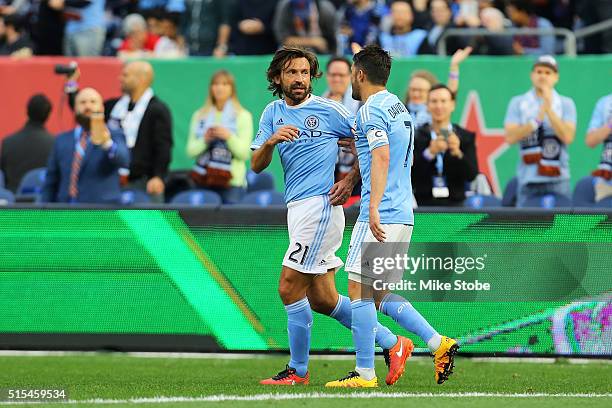 David Villa of New York City FC celebrates his first half goal with teamate Andrea Pirlo againd the Toronto FC at Yankee Stadium on March 13, 2016 in...