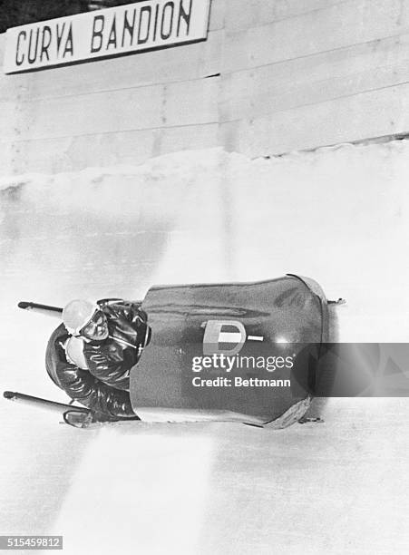 Lamberto Dalla Costa, 35 year old jet pilot in the Italian Air Force and his brakeman Giacomo Conti are shown darting down Cortina's 1,700 meter run...