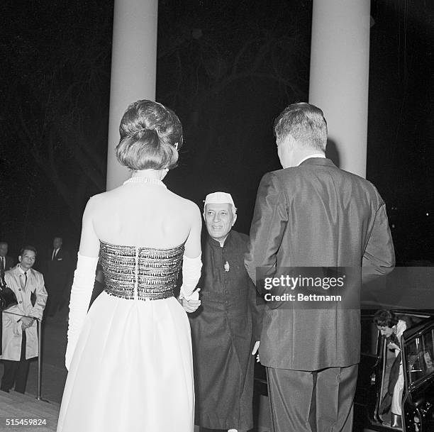 President Kennedy and the First Lady greet Indian Prime Minister Nehru as he arrives at the White House tonight for a small private black tie dinner...