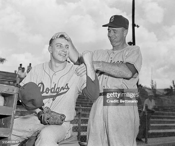 "Let's do it again this year," seems to be the reaction of Dodger manager Walt Alston as he musses the hair of World Series ace Johnny Podres. Podres...