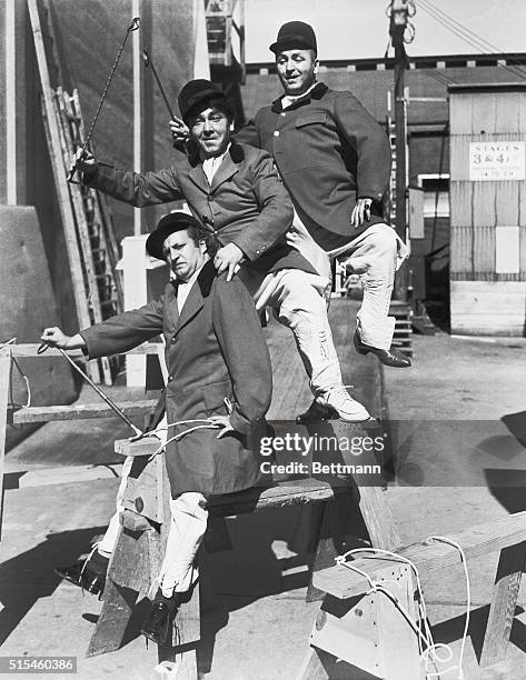 Hollywood's Stooges , seem to be under the cowboy influence as they go "riding" around the set. Top to Bottom: Jerry Howard, Moe Howard and Larry...