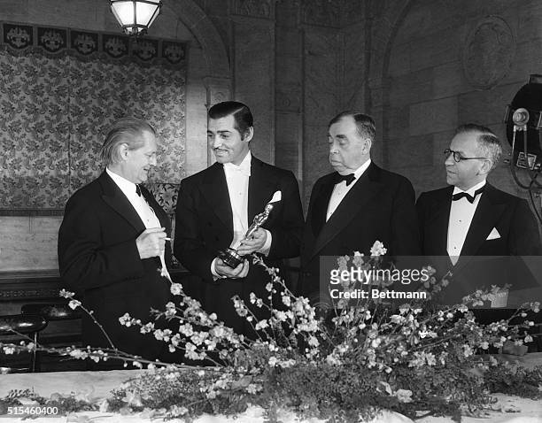 Left to right: Lionel Barrymore, Clark Gable, Irvin Cobb, famous humorist, and Nathan Levinson are photographed at the dinner given by the Motion...